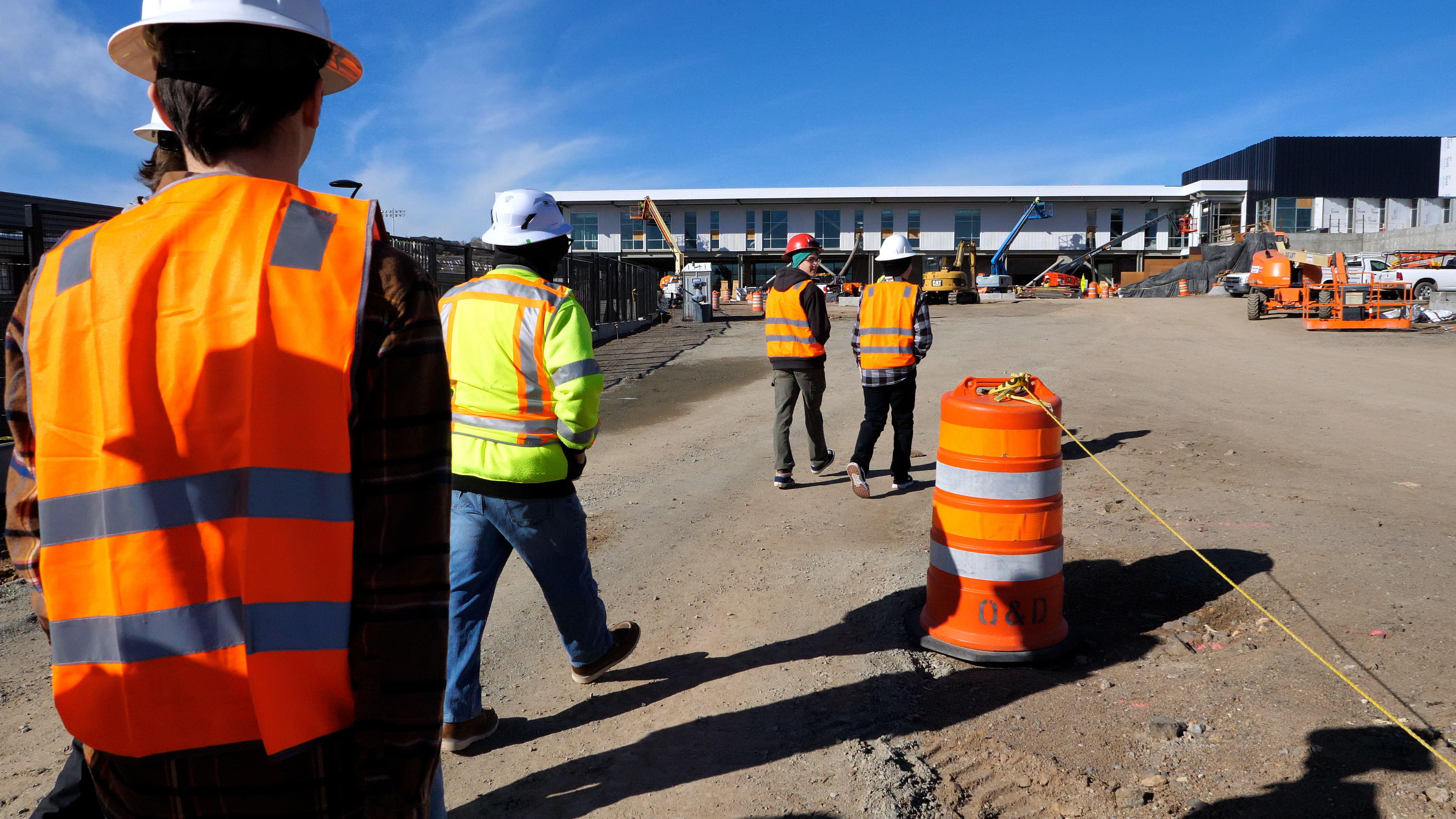  men walking on construction site